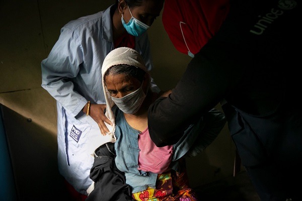 A-Rohingya-woman-being-inoculated-against-Covid-19-at-a-refugee-camp-in-Coxs-Bazar