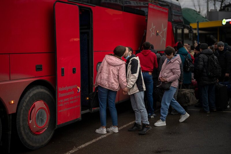 Russia-Ukraine: WAR in Photos 4 A couple kiss goodbye before the woman boards a bus out of Kyiv on Feb 24